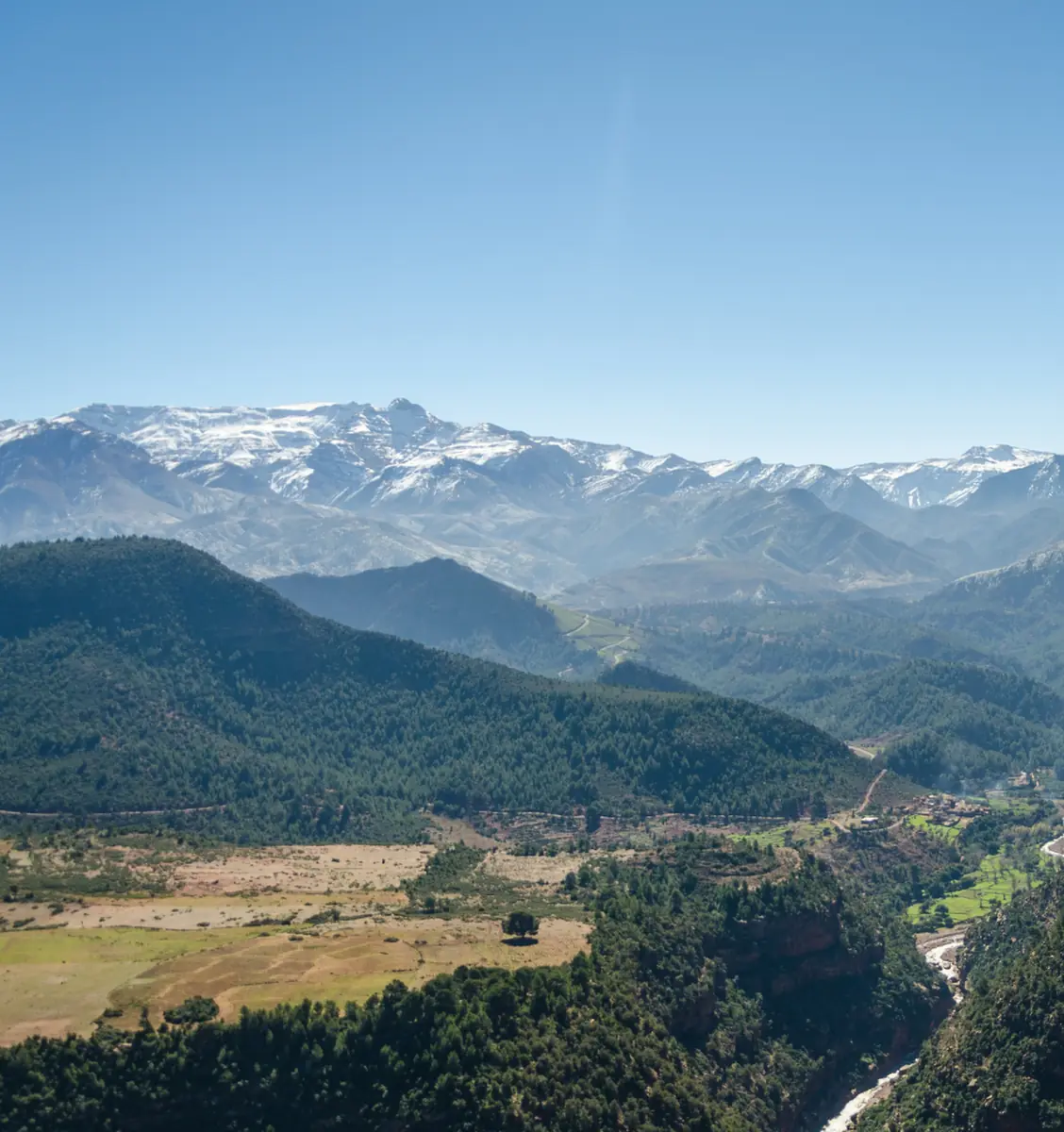 Snow-capped High Atlas peaks above green mountain valleys