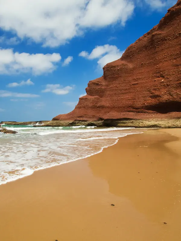 Red cliffs above a wide Atlantic beach