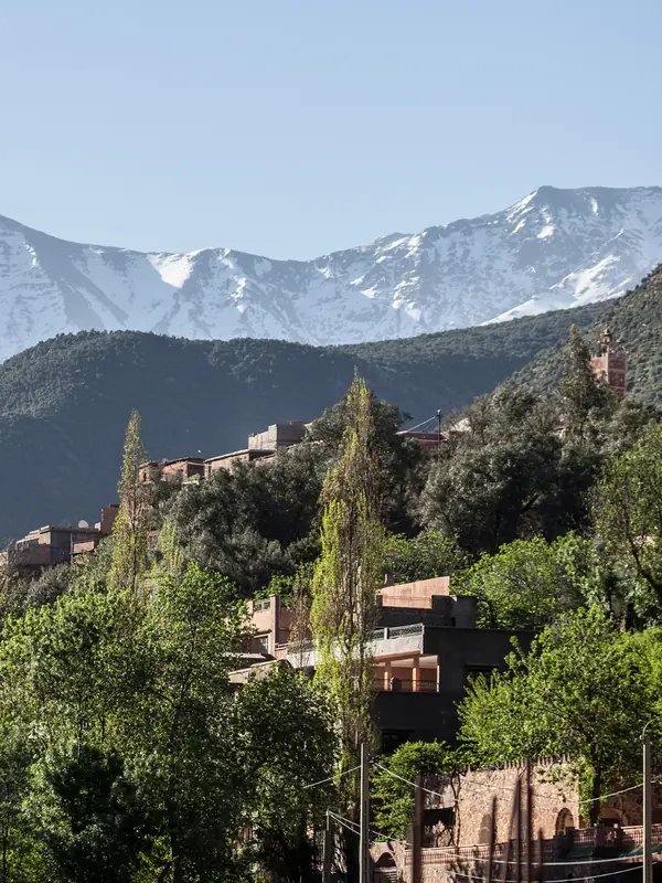 Snowy Atlas peaks above a green mountain village